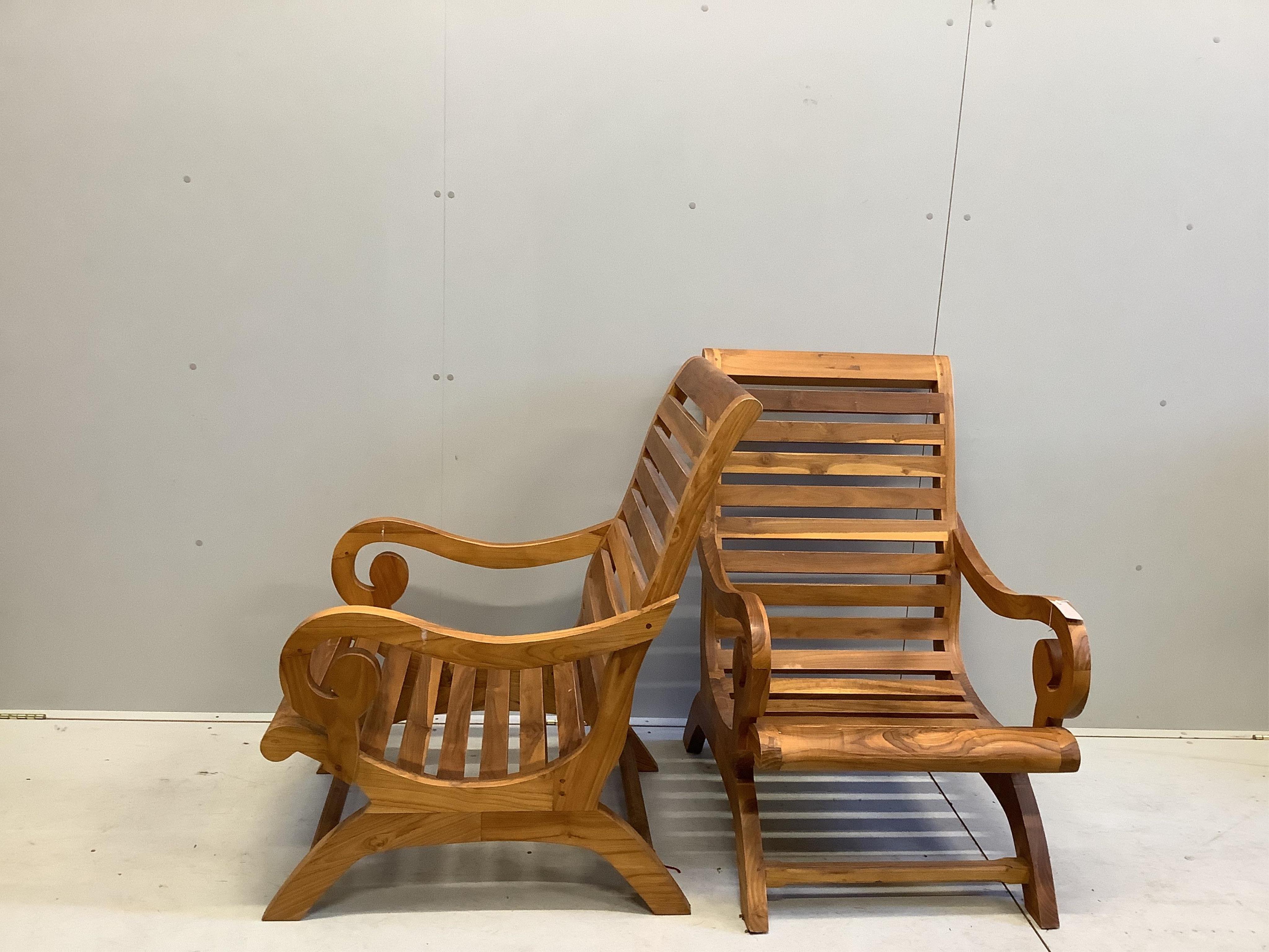 A pair of stained hardwood garden armchairs, width 64cm, depth 77cm, height 100cm. Condition - good